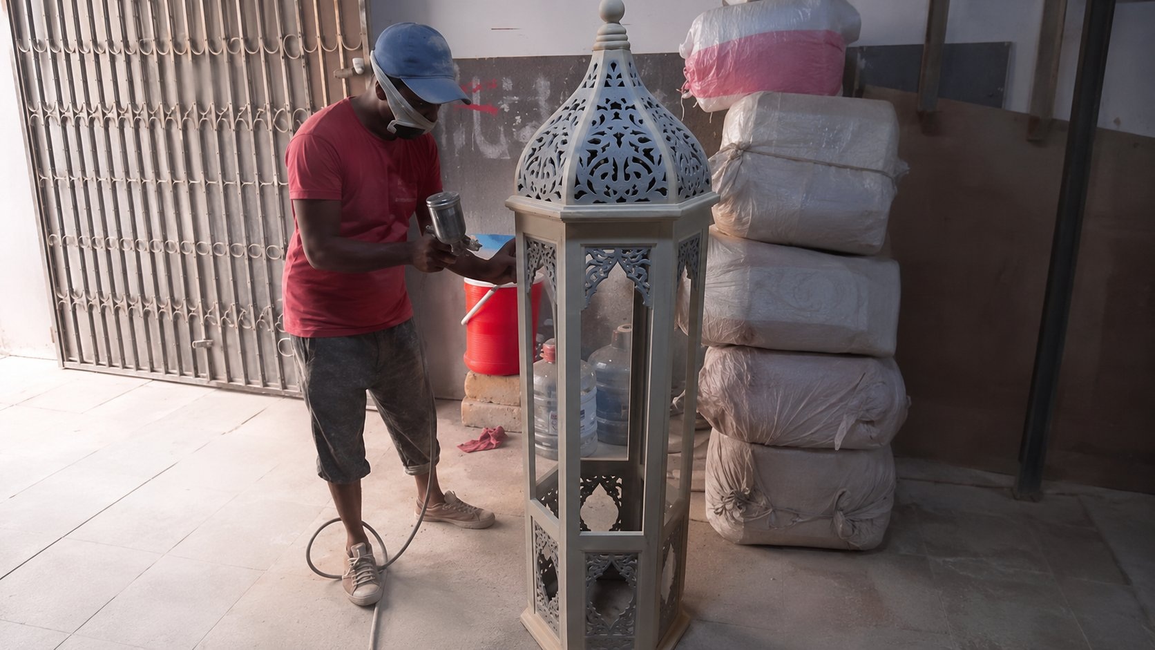 Spray finishing 6ft carved wooden lantern